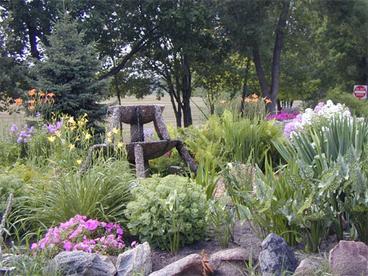 garden plants with a stone fountain 