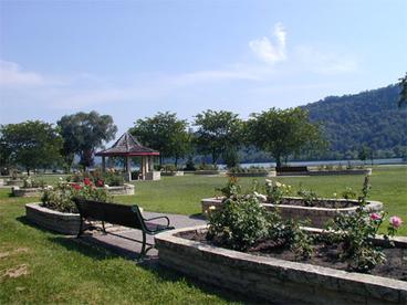 raised beds, benches and grass with the lake in the background