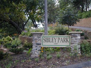 Sibley Park sign with trees in the background
