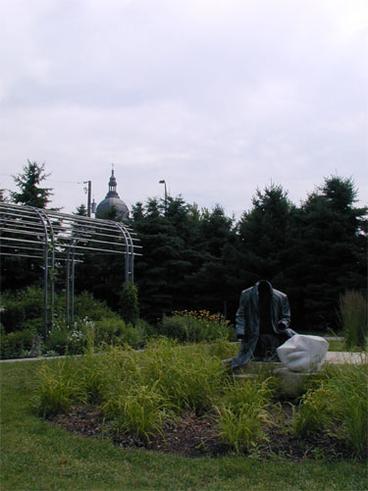 statue surrounded by garden plants
