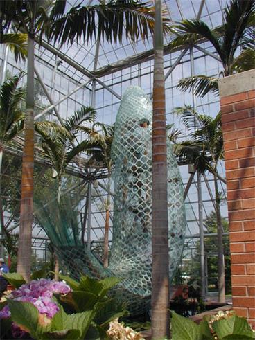 sculpture of a fish inside glass building 